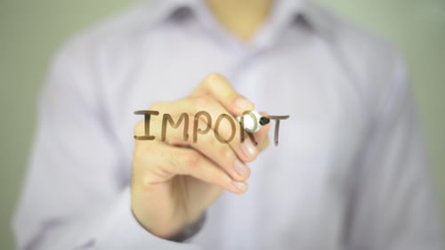 Hand Writes Import With Marker On Glass