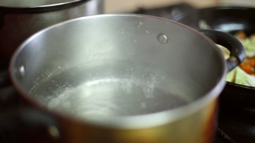 Water Boiling in Silver Pot on Stove
