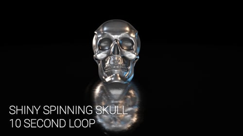 Shiny Metallic Skull Spinning on Reflective Surface