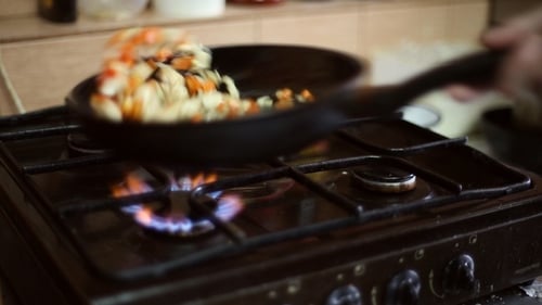 Vegetables Sautéed in Pan on a Gas Stove