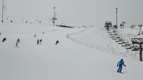 Skiers and Snowboarders on Snow Covered Mountain