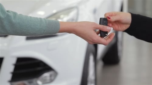 Saleswoman Giving Car Key