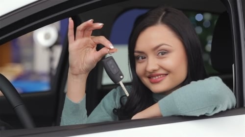 Female Showing The Key Of Her New Car