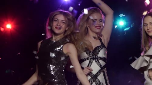 Dancing Girls Under Flying Glitter Confetti. Close-up on Each