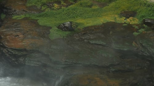 Flowing Waterfall Splashing On Rock