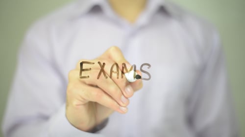 Hand Writes Exams on Transparent Screen with Marker