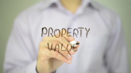 Man Writes Property Value on Glass