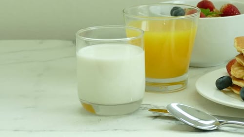 Pancakes, Milk, and Orange Juice Sit Together
