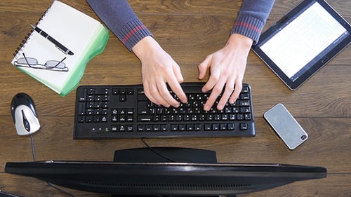 Overhead Working At Wood Desk