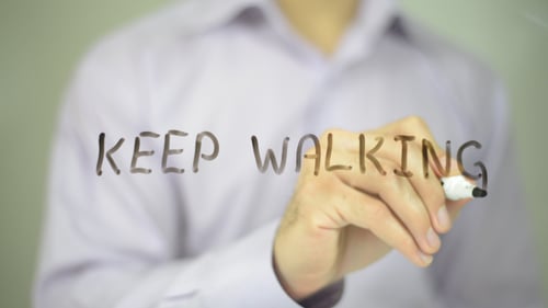 Hand Writes Words Keep Walking on Clear Surface