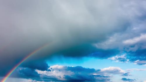 Rainbow Appears After Storm in the Cloudy Sky
