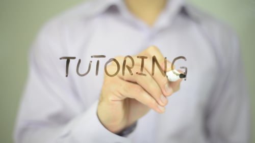Hand Writes Tutoring on Clear Surface
