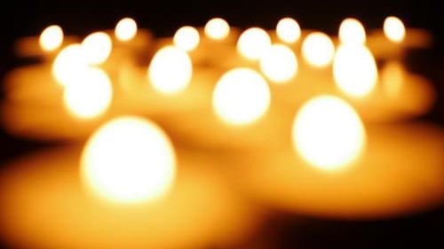 Many Flickering Candles Glowing in the Dark