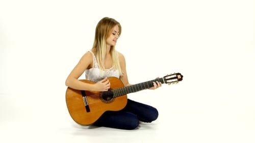 Woman Plays Guitar in a Bright White Studio