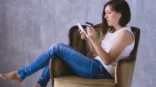 Woman Shopping Online with Phone and Credit Card