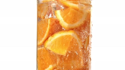 Refreshing Orange Slices and Ice Cubes in Glass