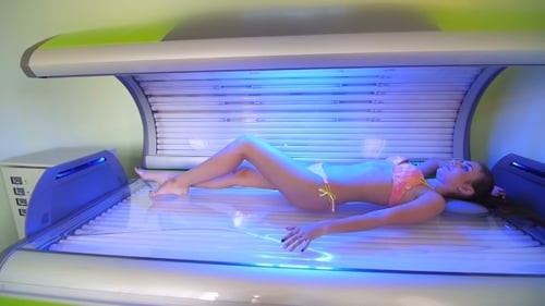 Woman Lying in a Modern Tanning Bed