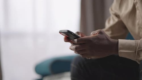 Young Adult Using Smartphone Indoors