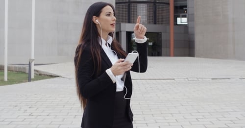Stylish Woman Talking on Smartphone in City