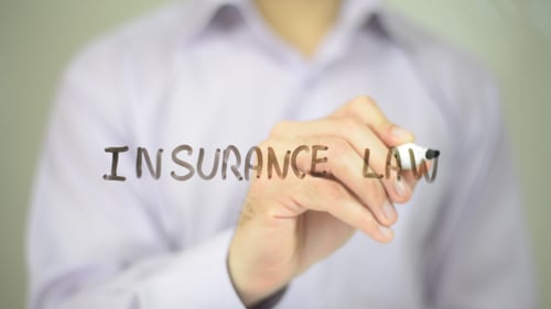 Hand Writing Insurance Law on Transparent Screen