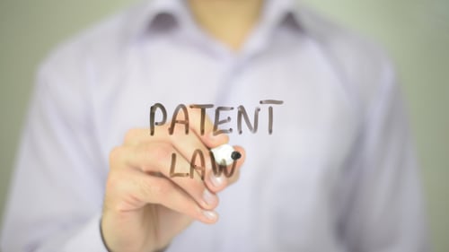 Hand Writing Patent Law with Black Marker