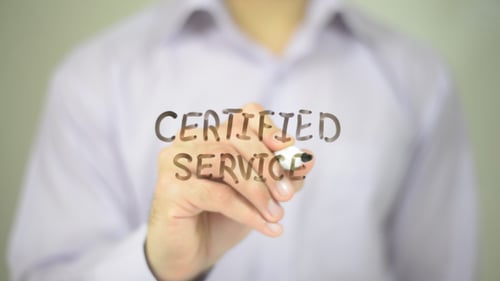 Man Writes Certified Service on Glass Surface