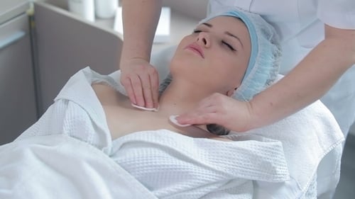 Young Woman Receiving Facial Treatment at Spa