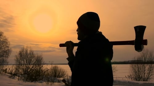 Bearded Man with Axe During Winter Sunset