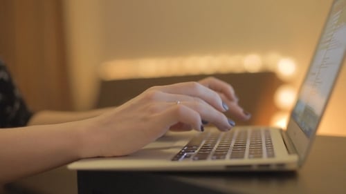 Close Up of Hands Typing on Laptop Keyboard