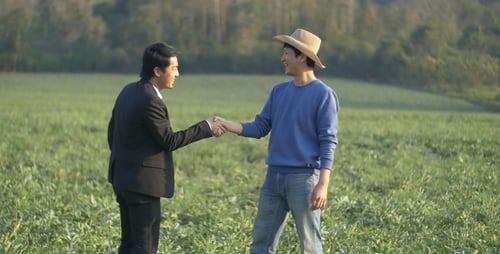 Farmer And Businessman Shaking Hands