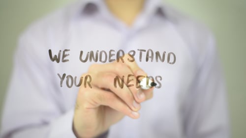 Man Writes 'We Understand Your Needs' on Glass