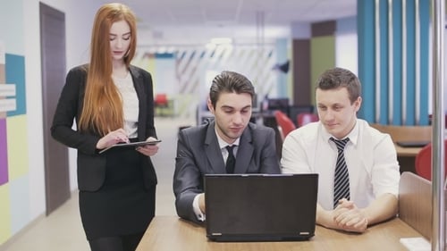 Three Business People Meeting In Office.
