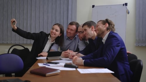 Business People Making Face While Taking Selfie In Office