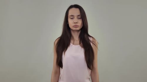 Woman Gives Okay Sign in Simple Studio Shot