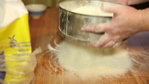 Hands Sifting Flour for Baking at Home