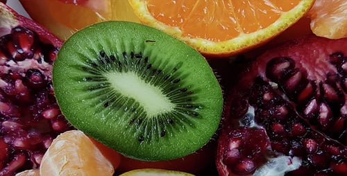 Colorful Fresh Fruits Close-Up: Oranges, Kiwi, Pomegranate