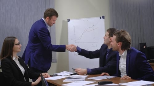 Business Team Celebrates Success in Office Presentation