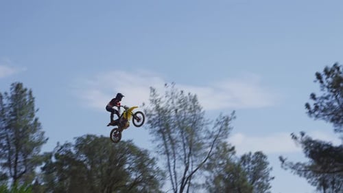 Dirt Biker Jumps and Flies Over a Ramp