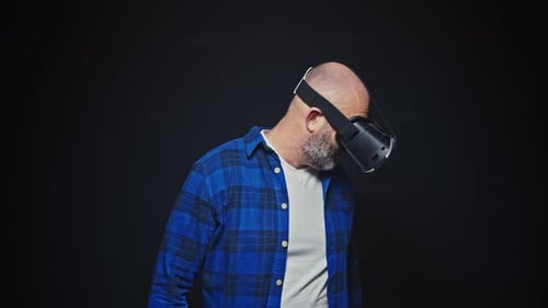 Man Using Virtual Reality Headset in Dark Studio