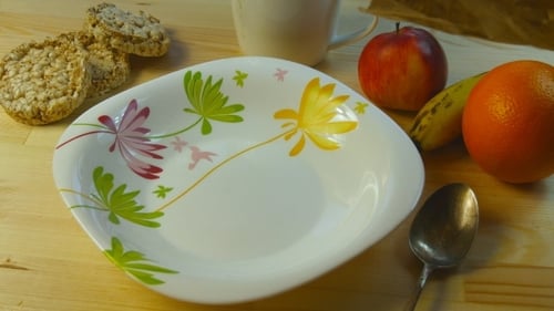 Golden Cornflakes Being Poured Into a Bowl