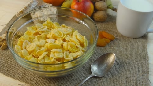 Cereals, Milk, and Fruit on a Burlap Table