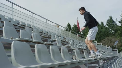 Man running up and down stadium steps