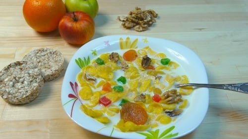 Breakfast of Cornflakes, Milk, Nuts, and Dried Fruit