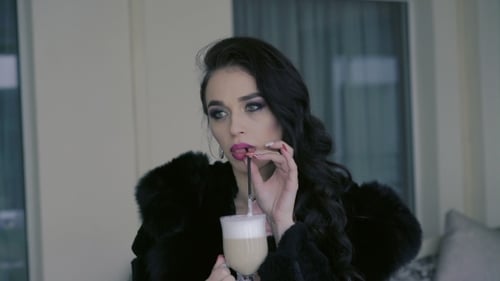 Elegant Woman Sitting In Cafe Drinking Latte