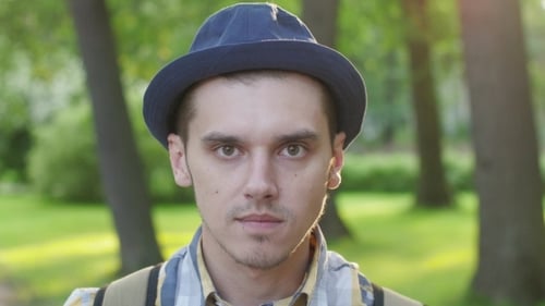 Young Man in Hat, Close-Up Portrait in Park