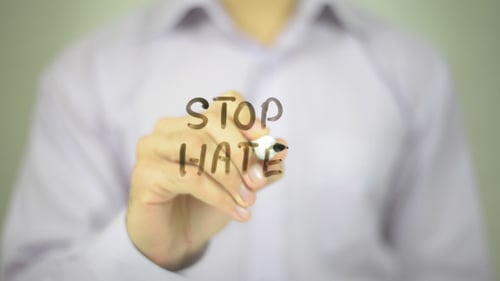 Man Writes Stop Hate on Glass Surface