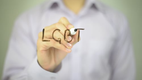 Hand Writes LGBT on Clear Screen