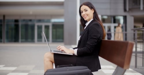 Professional Woman Working on Laptop in City