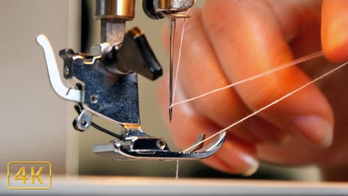 Threading a Sewing Machine Needle in Extreme Close Up