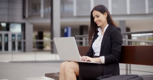 Professional Woman Working on Laptop Outdoors
